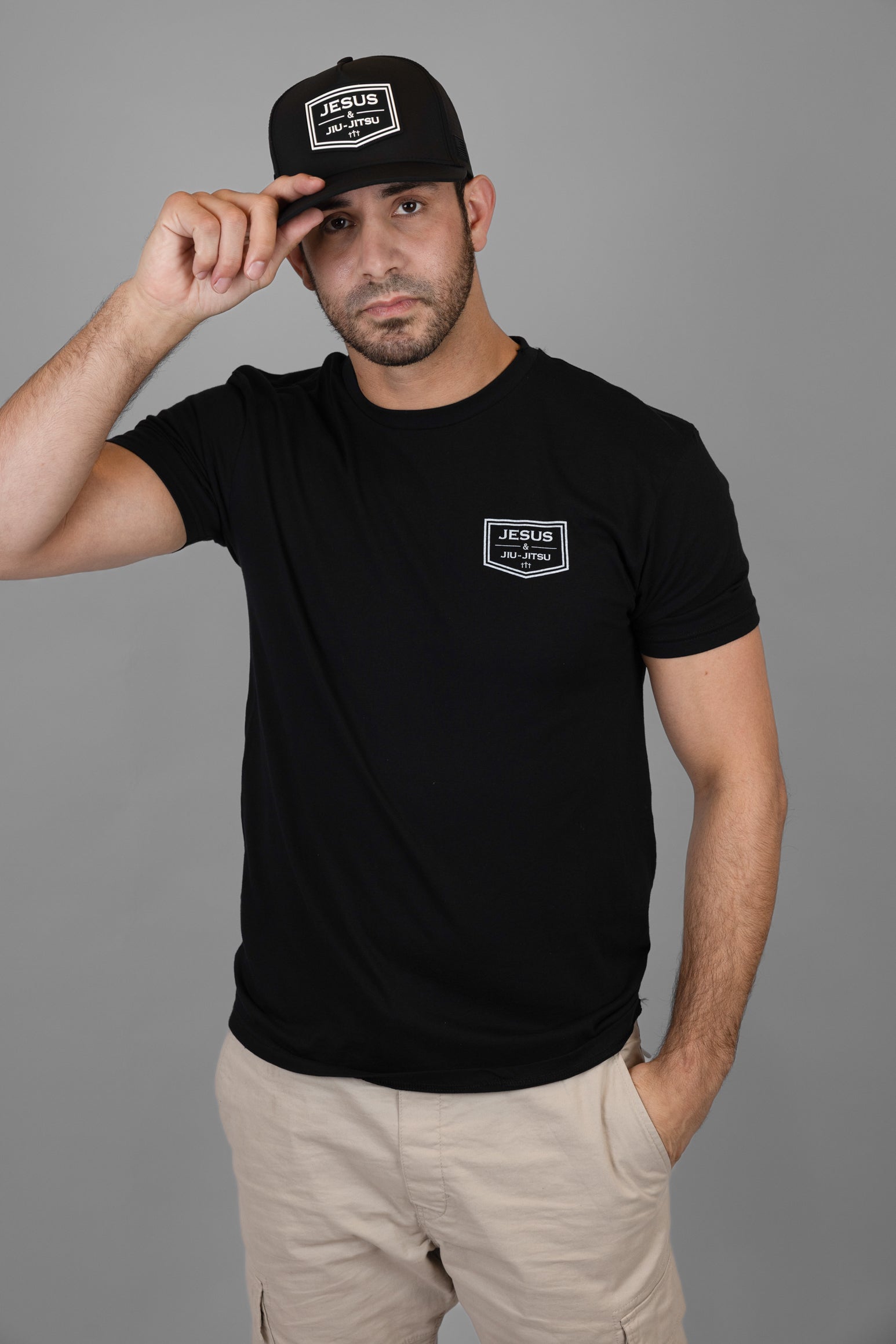 Man wearing black hat with "JESUS & JIU-JITSU" logo on front