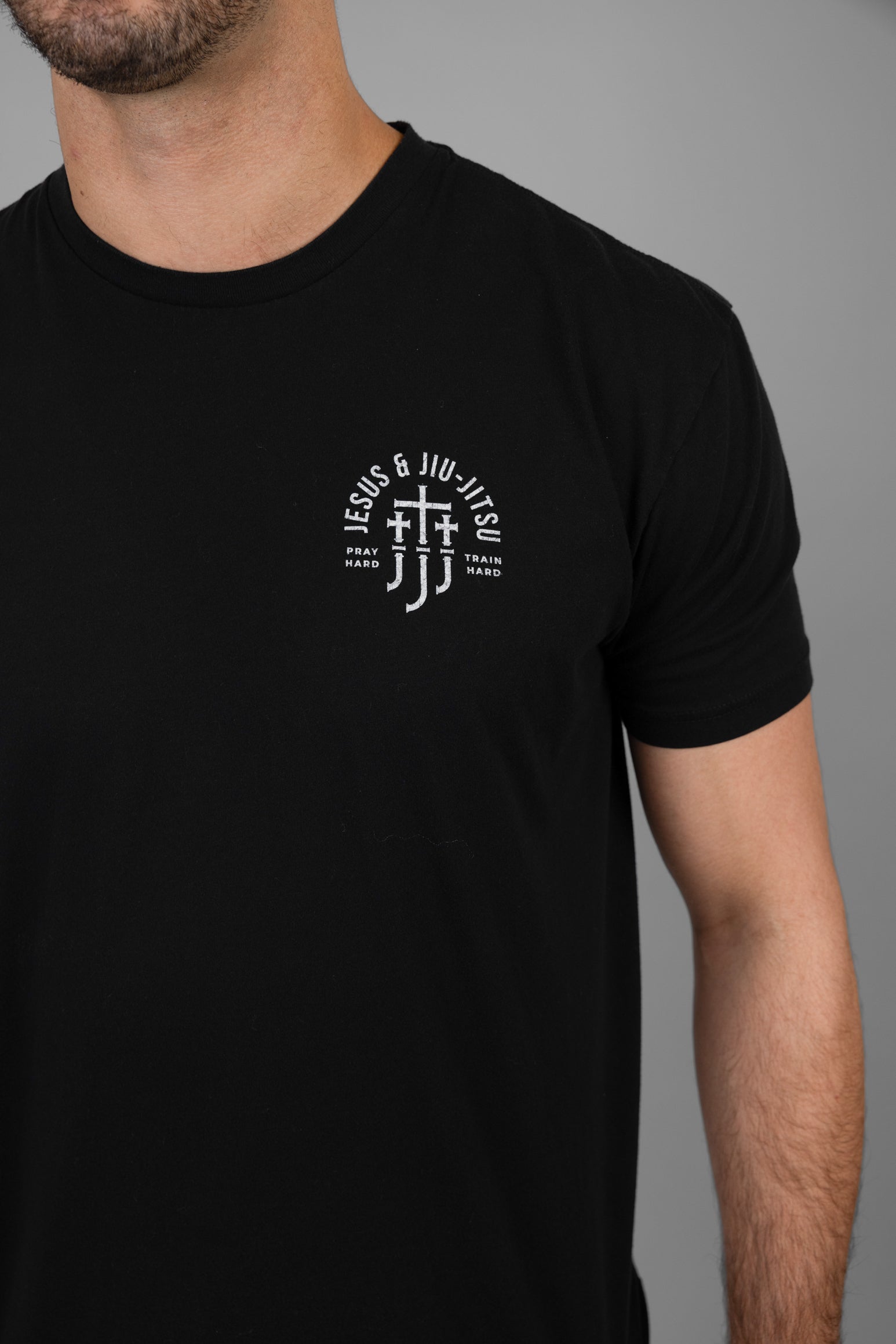 Black t-shirt with a white JJJ logo on a gray background