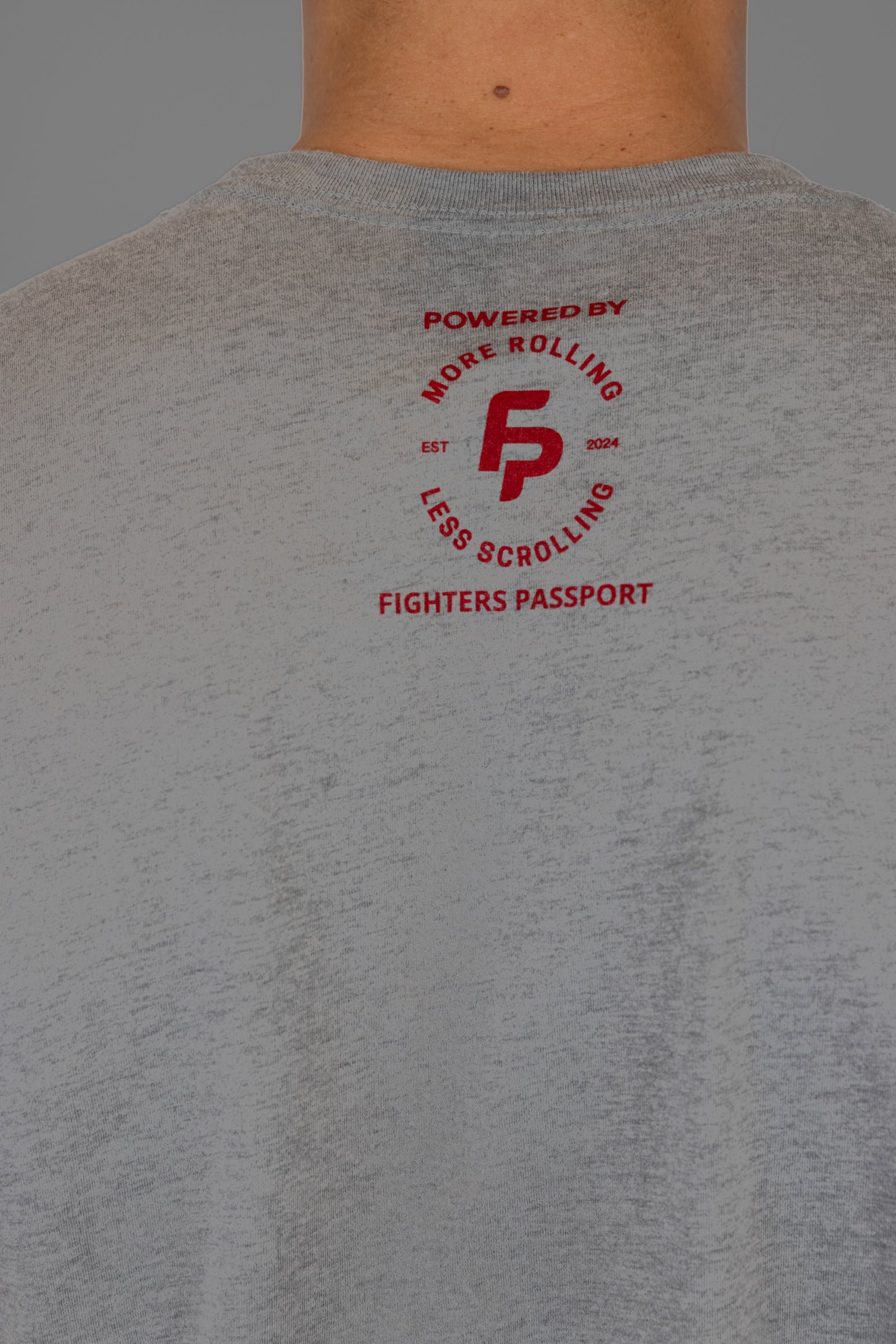 Rear view of man wearing gree tee showing "MORE ROLLING LESS SCROLLING" logo