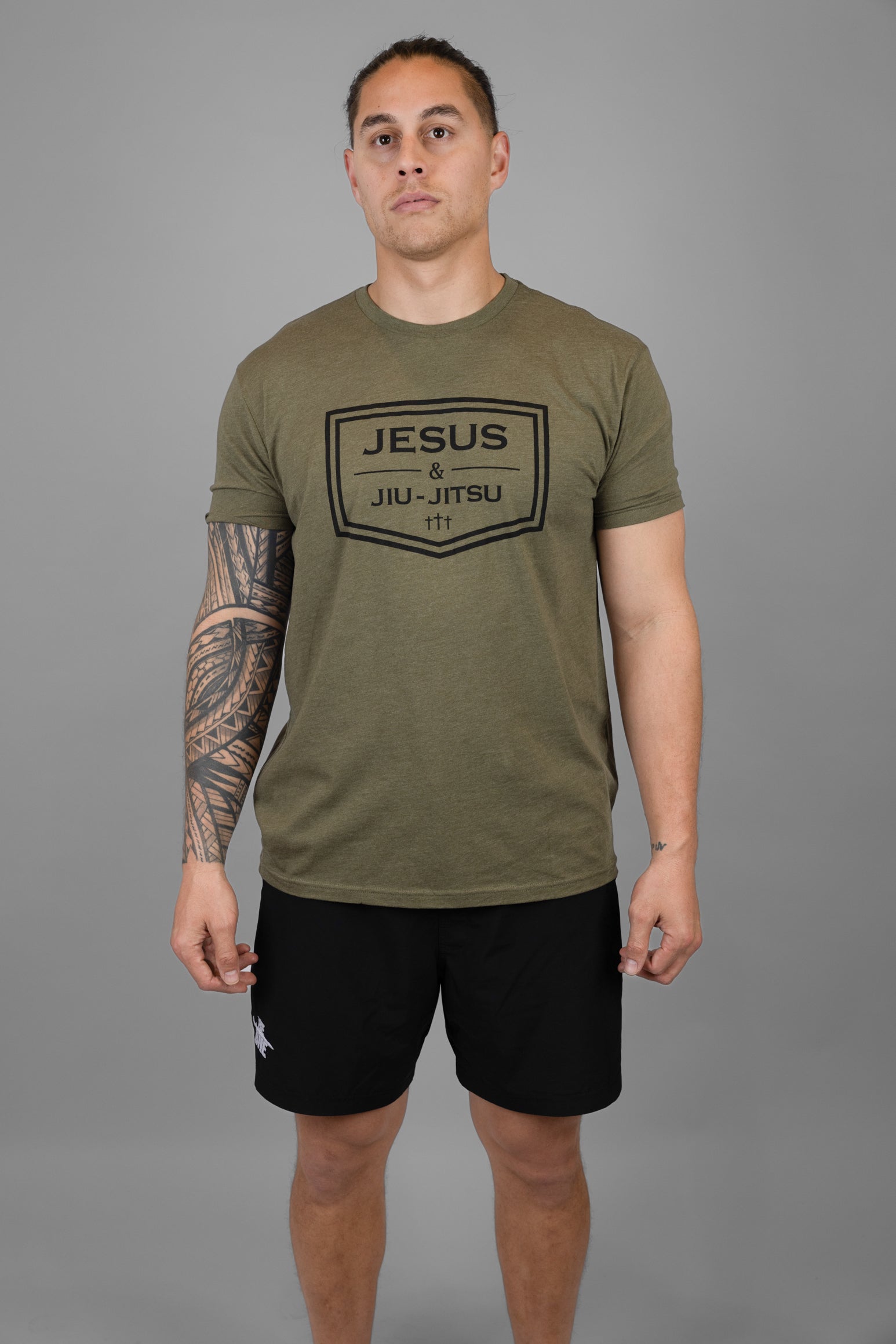 Man wearing green tee with black JESUS & JIU-JITSU logo
