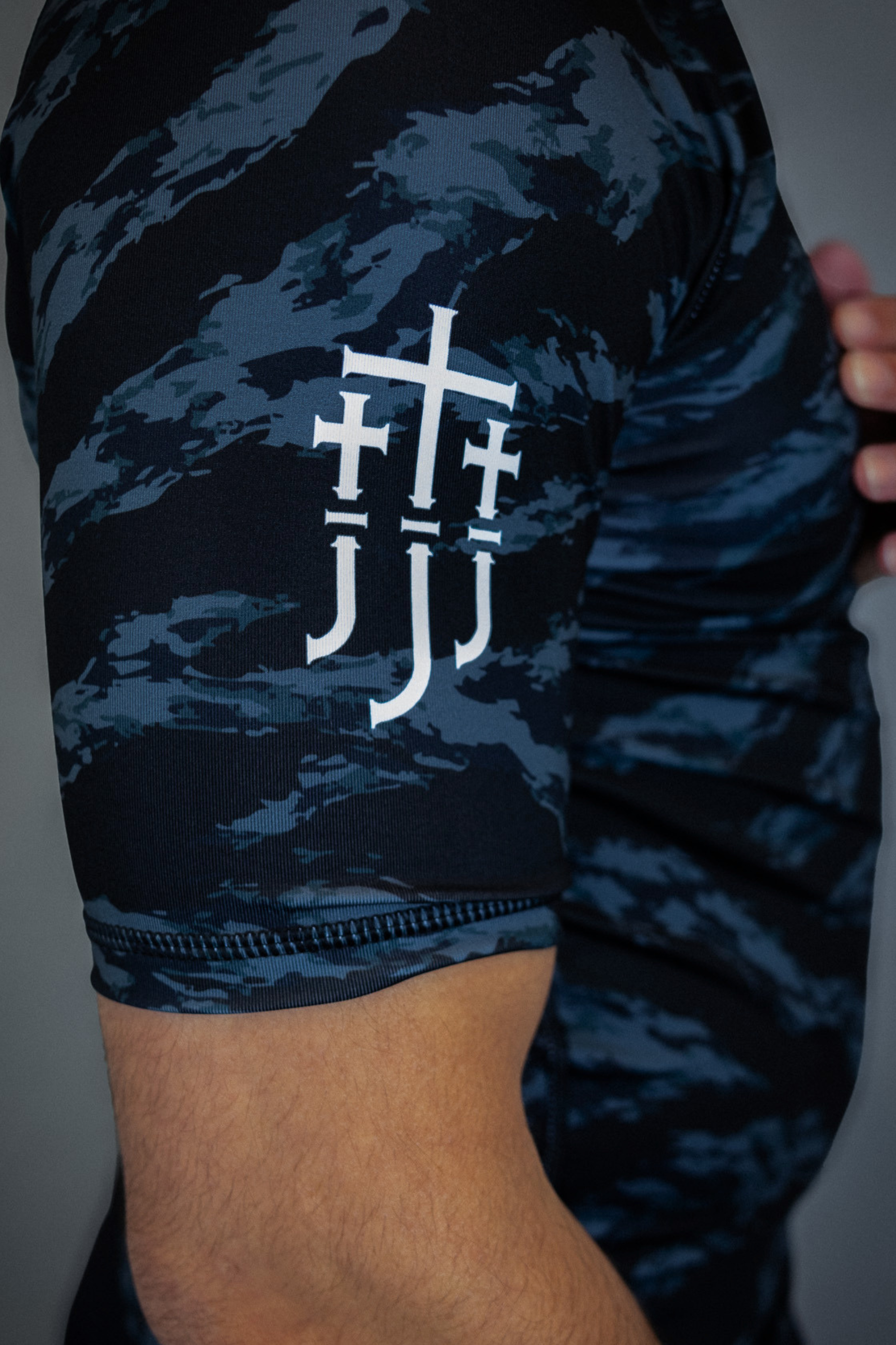 camo rashguard showing JJJ logo on right sleeve