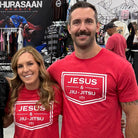 Woman and Man in red shirts with white JESUS & JIU-JITSU logo