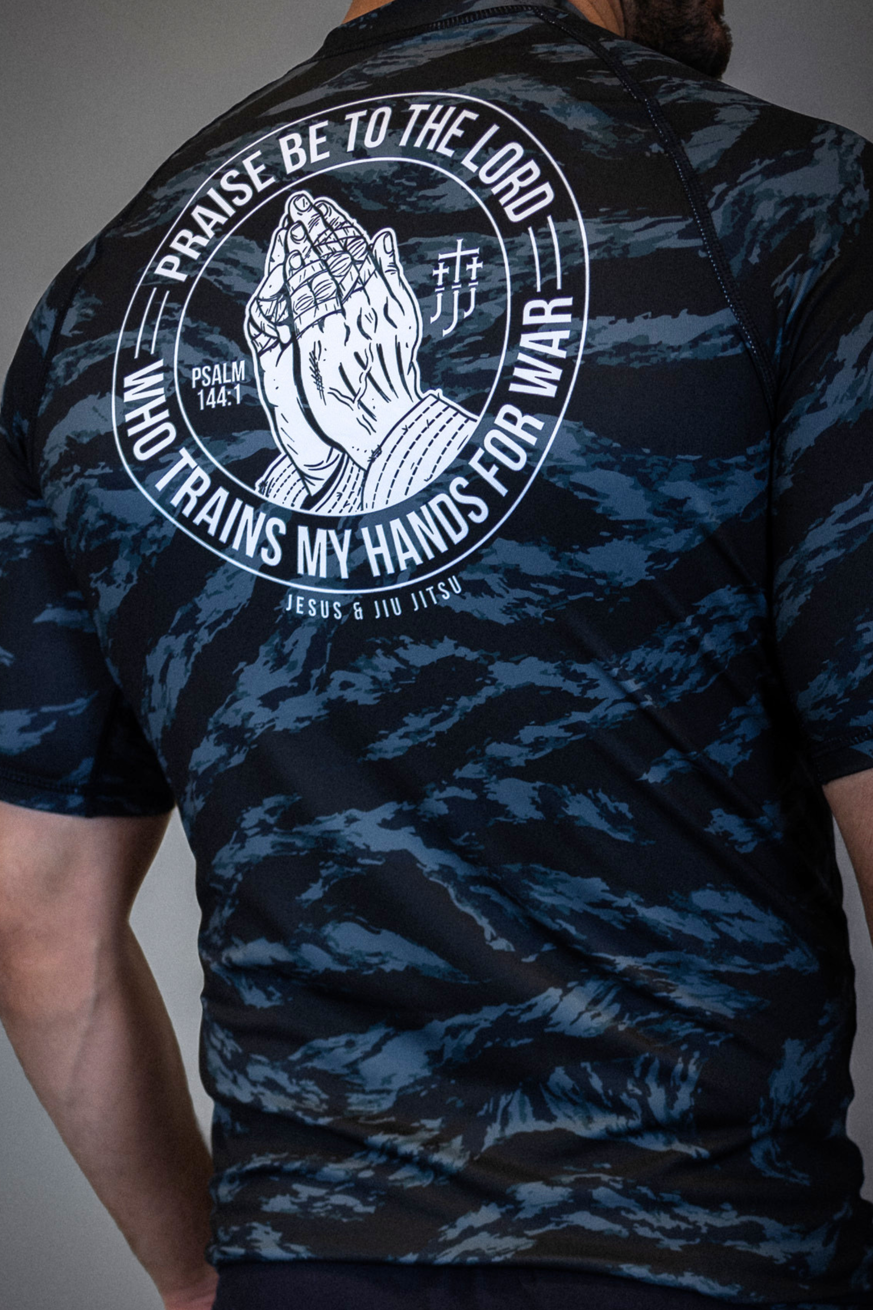 Rear view of camo rashguard showing Prayer hands graphic