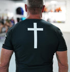 Man wearing rashguard with cross on back