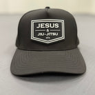 Black cap with 'Jesus & Jiu-Jitsu' logo on a light gray background