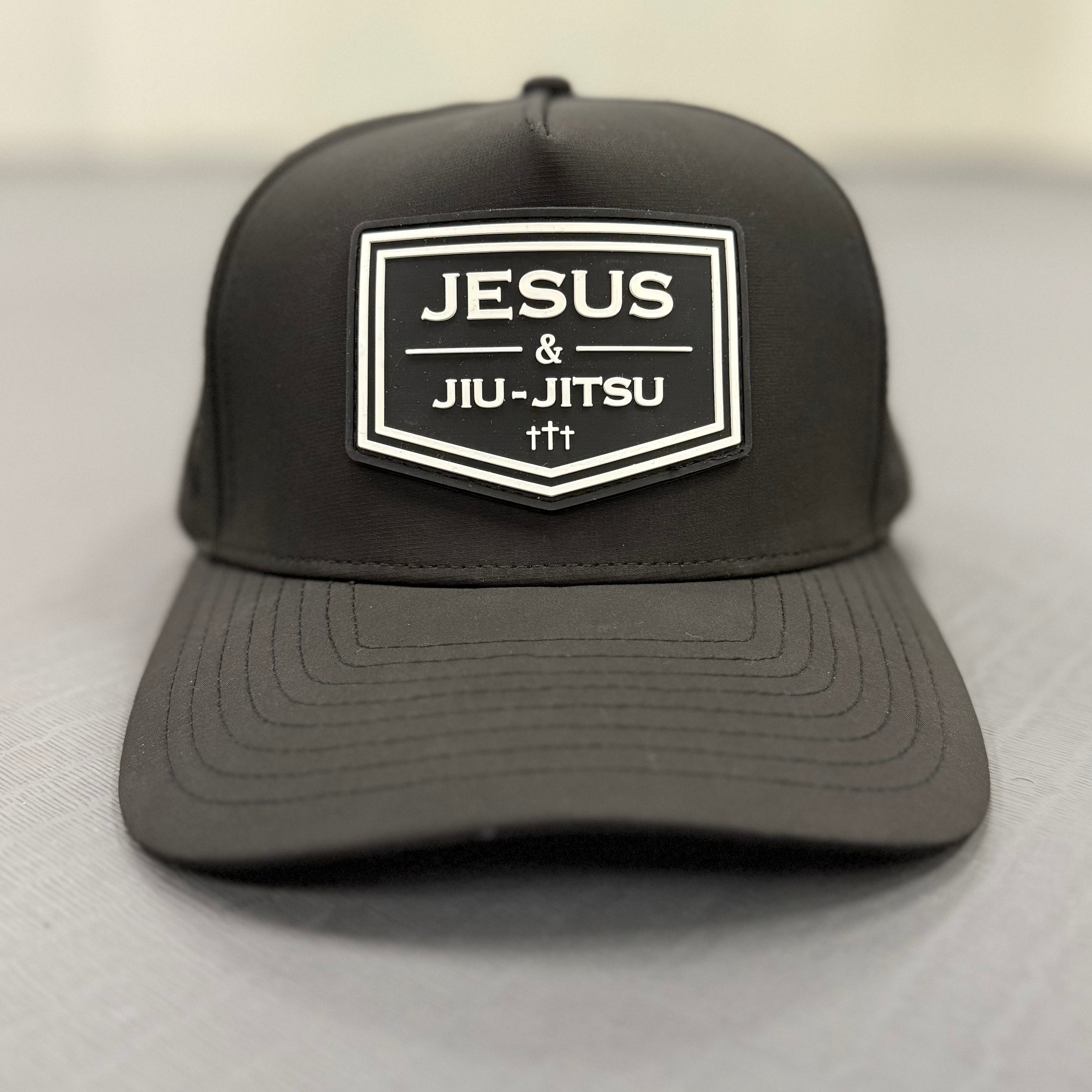Black cap with 'Jesus & Jiu-Jitsu' logo on a light gray background