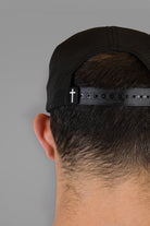 back view of black hat with cross woven label