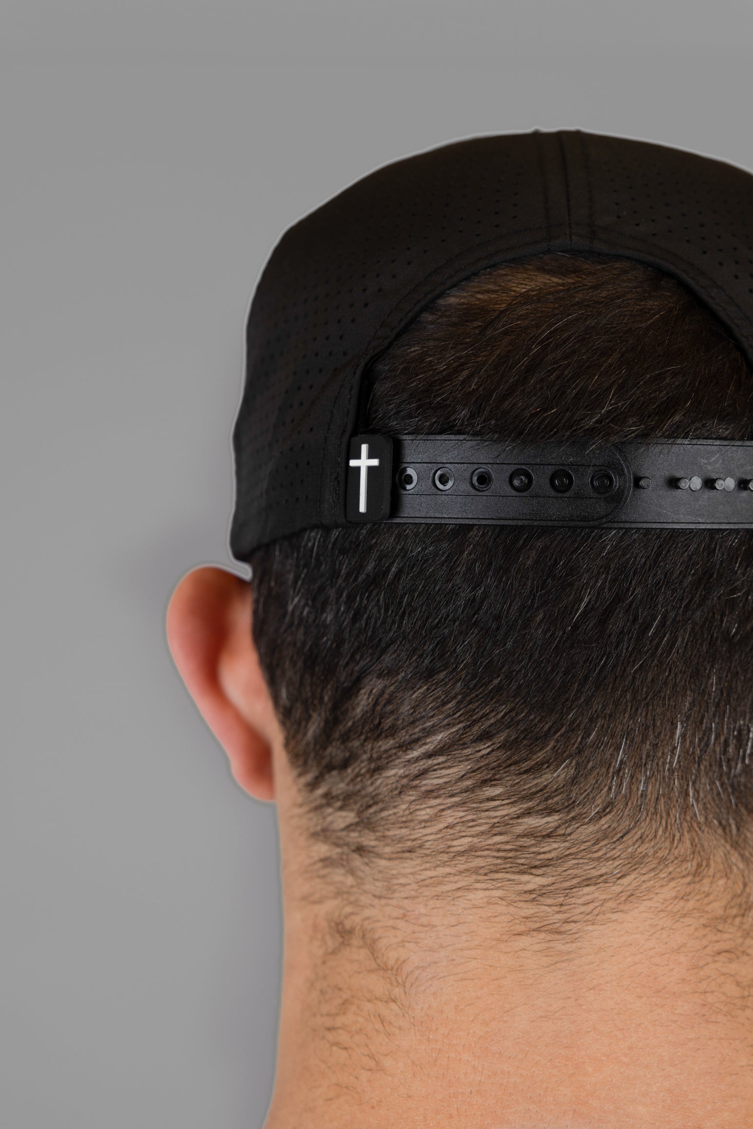 back view of black hat with cross woven label