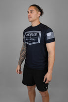 Man wearing rashguard with "JESUS & JIU-JITSU" logo on front and flag on left shoulder