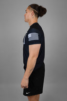 Man wearing rashguard with American flag on left shoulder