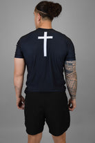Man wearing rashguard with cross on back