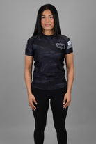 woman wearing black tiger camo rashguard with JJJ logo on left chest