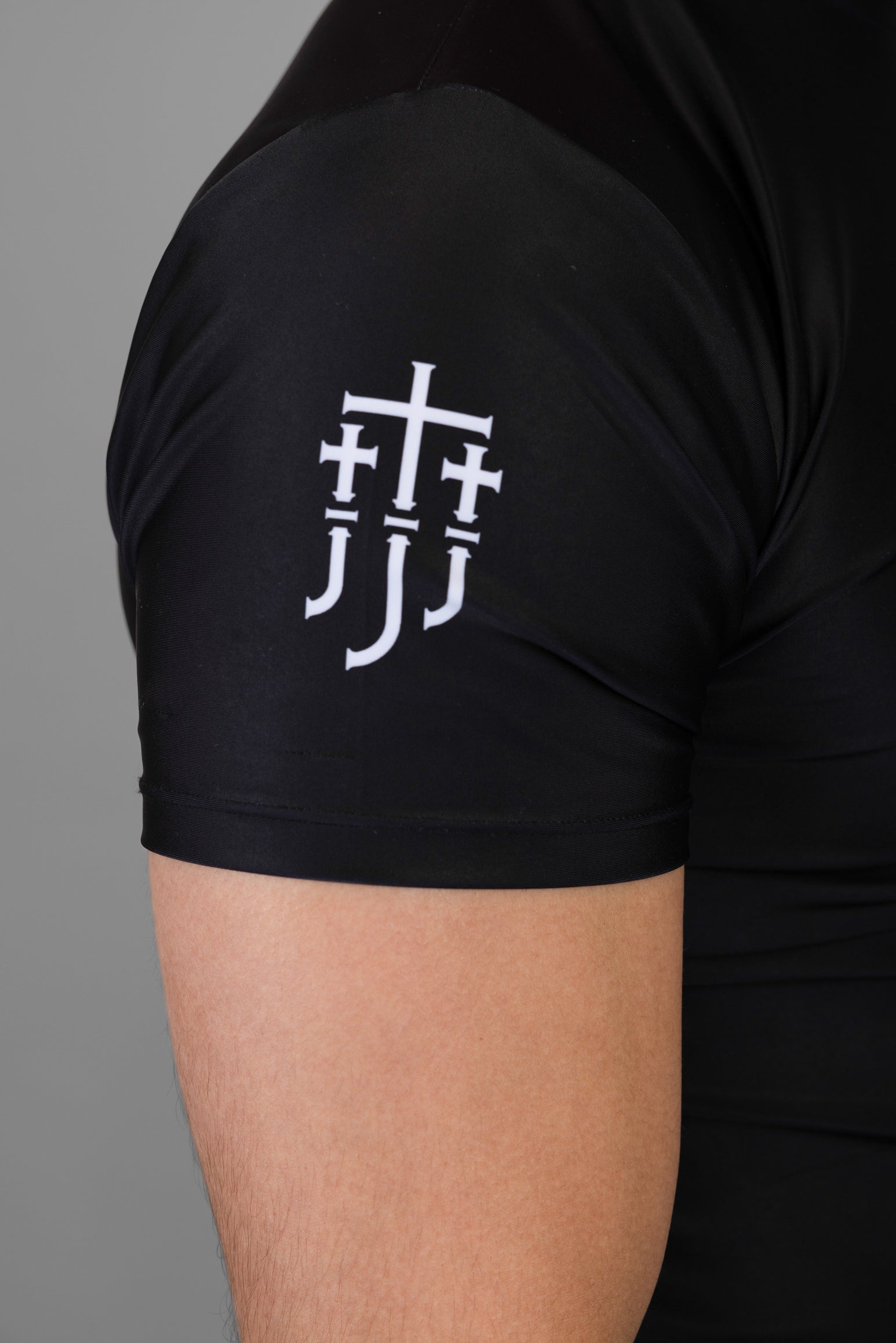 JJJ logo on right shoulder of black rashguard