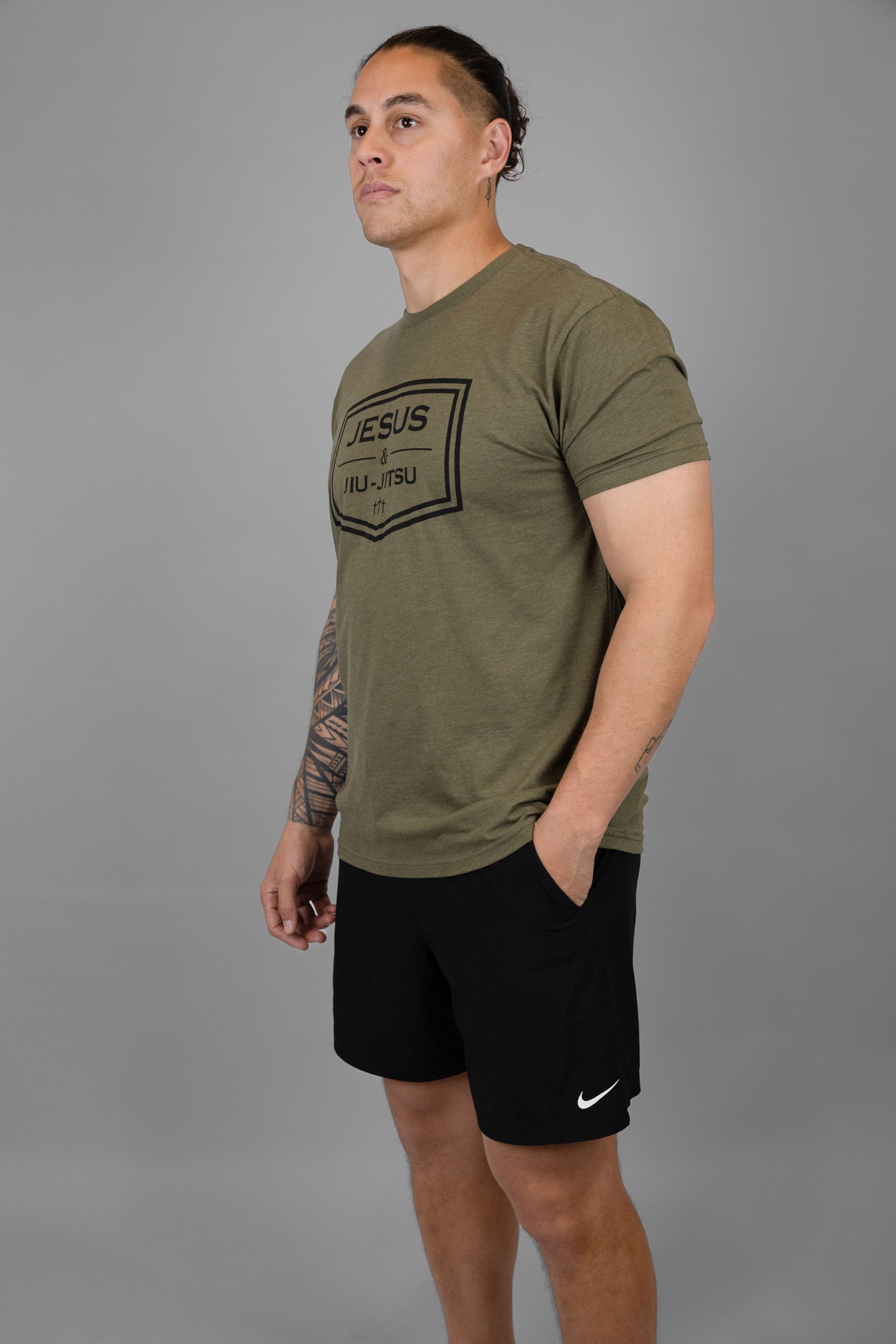 Man wearing green tee with black JESUS & JIU-JITSU logo