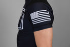 Man wearing rashguard with American flag on left shoulder