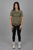 Woman wearing green tee with black JESUS & JIU-JITSU logo