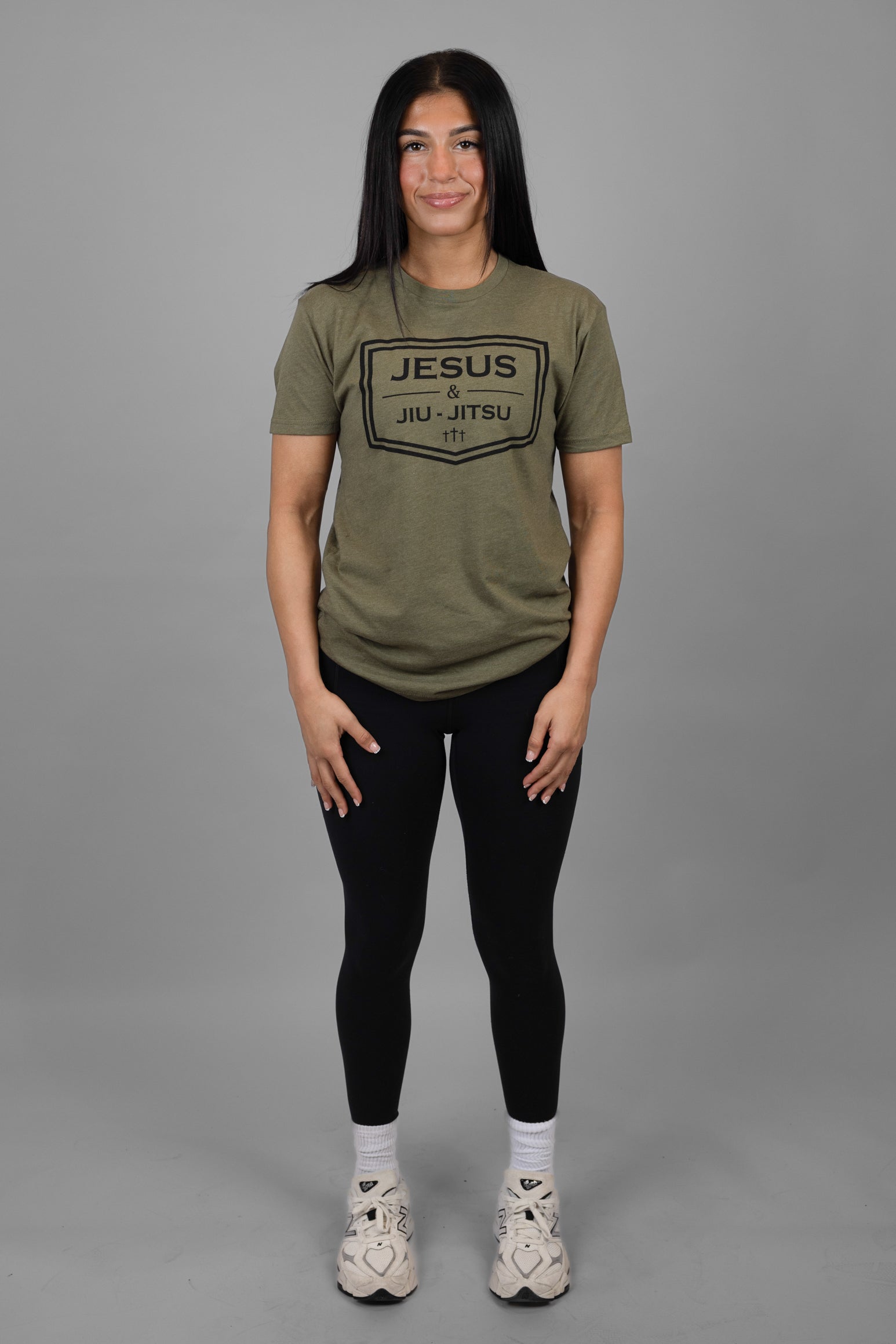 Woman wearing green tee with black JESUS & JIU-JITSU logo