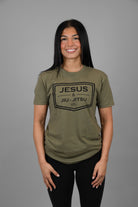 Woman wearing green tee with black JESUS & JIU-JITSU logo