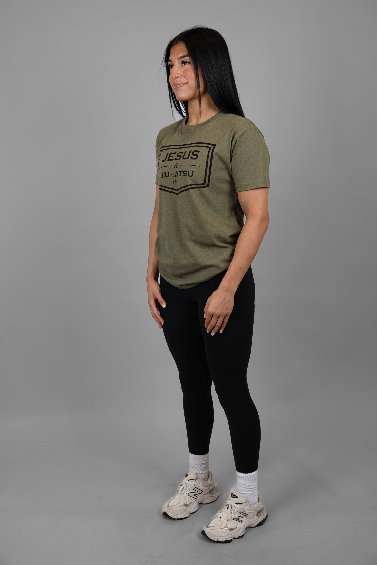 Woman wearing green tee with black JESUS & JIU-JITSU logo