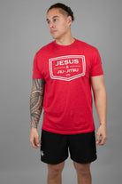 Man in red shirt with white JESUS & JIU-JITSU logo