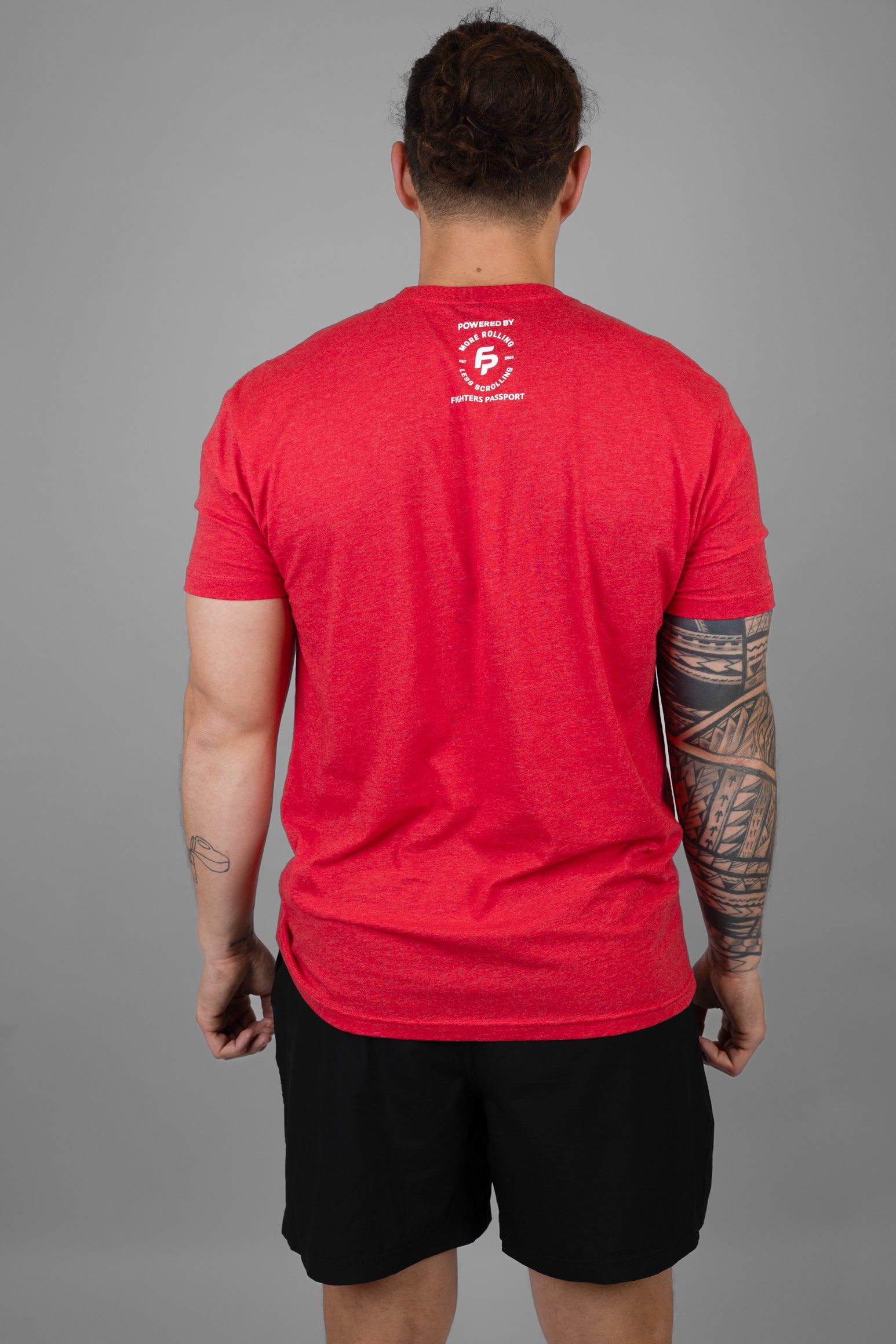 rear view of man in red shirt with logo on upper back