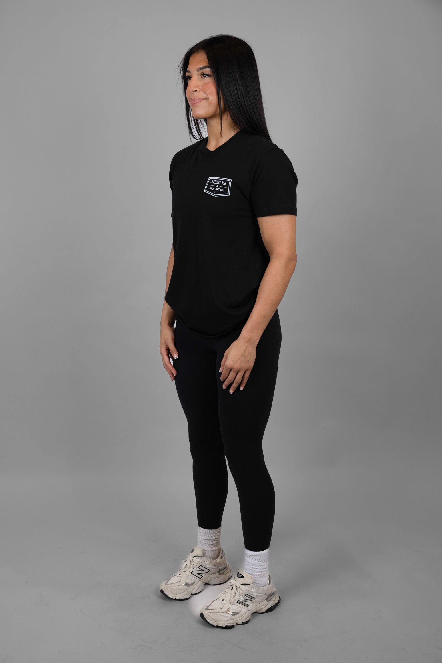 Person wearing a black t-shirt with "JESUS & JIU-JITSU" logo on left chest