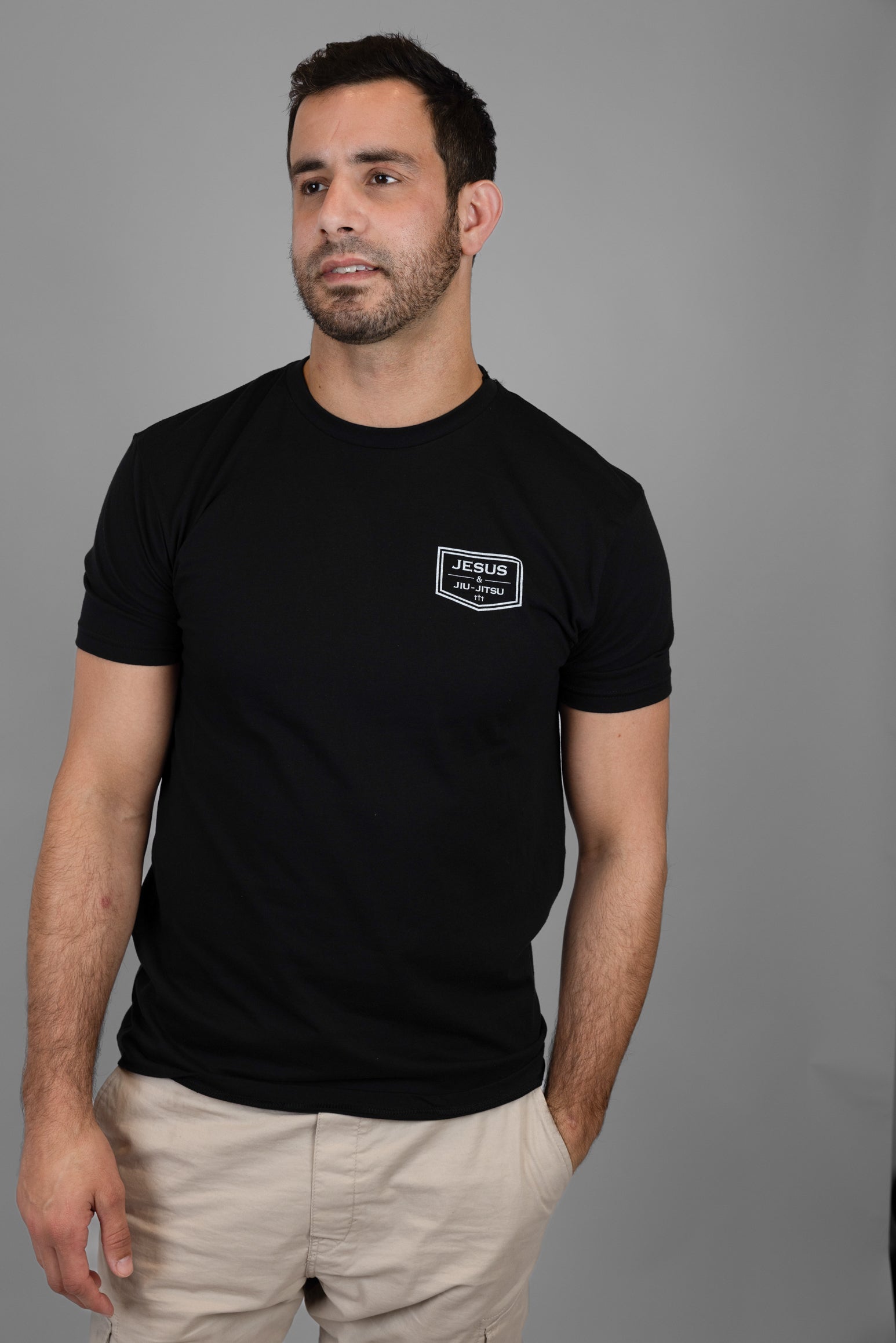 Man wearing shirt with JJJ logo on left chest