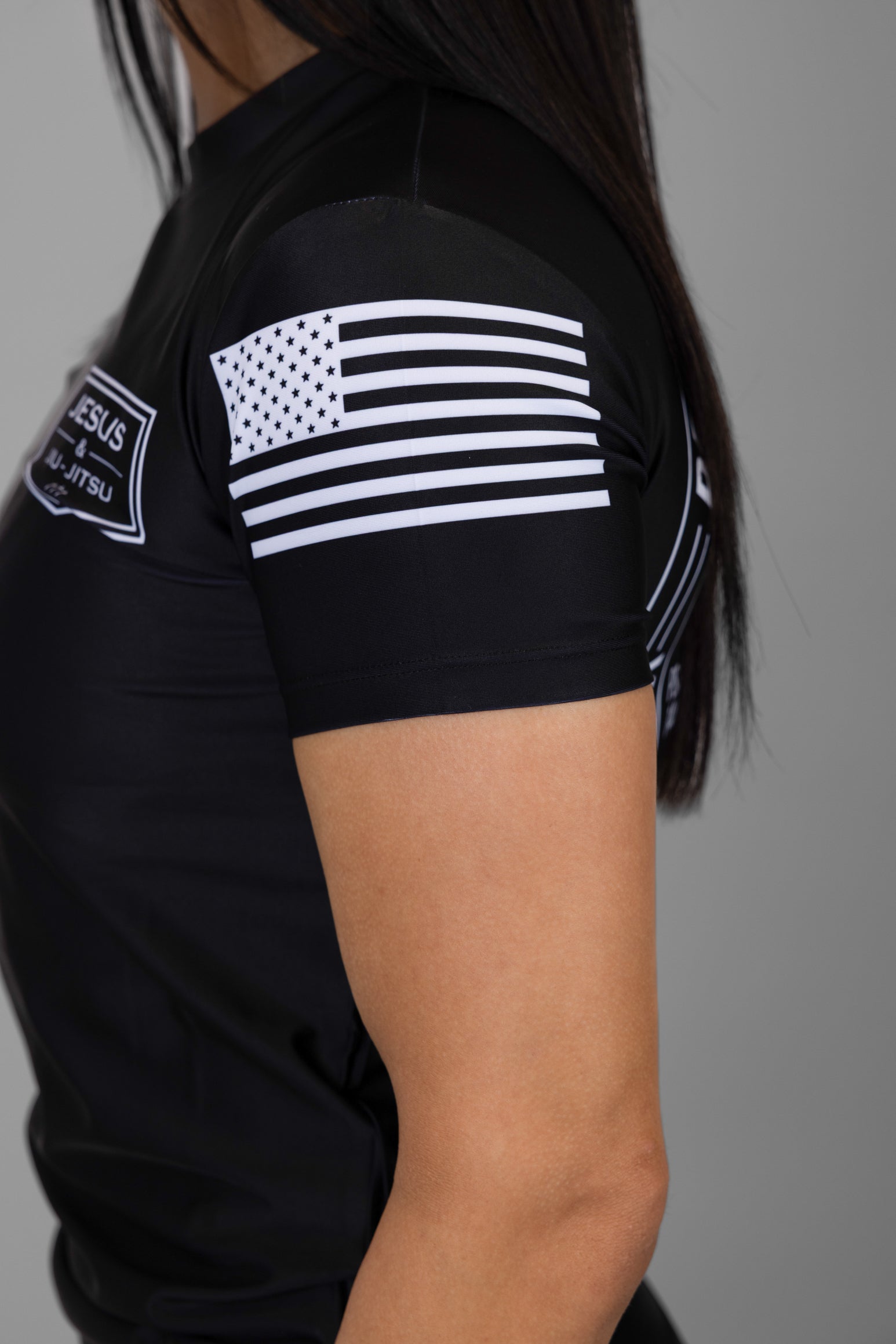 American flag on left sleeve of black rashguard
