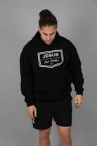 Man wearing black hoodie with JESUS & JIU-JITSU logo