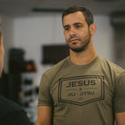 Man wearing green tee with black JESUS & JIU-JITSU logo