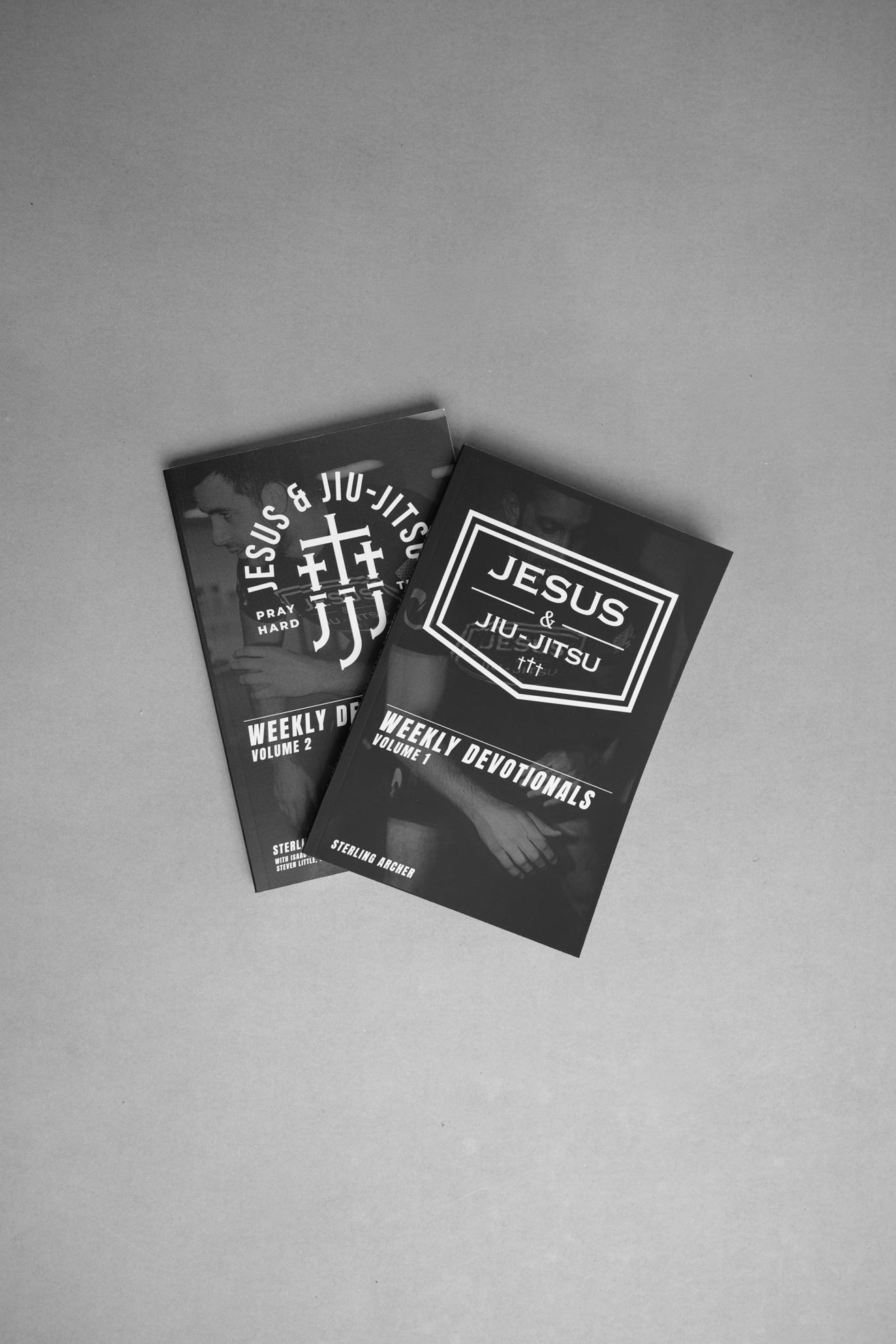 Two black Devotional books with white text on a gray background