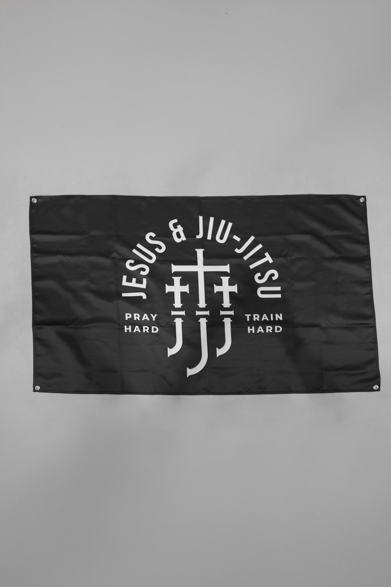 Black flag with Jesus & Jiu Jitsu logo featuring "PRAY HARD TRAIN HARD" text