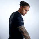 man wearing rashguard with JJJ logo on right shoulder