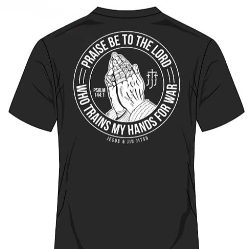 Black t-shirt with praying hands graphic and text on a white background
